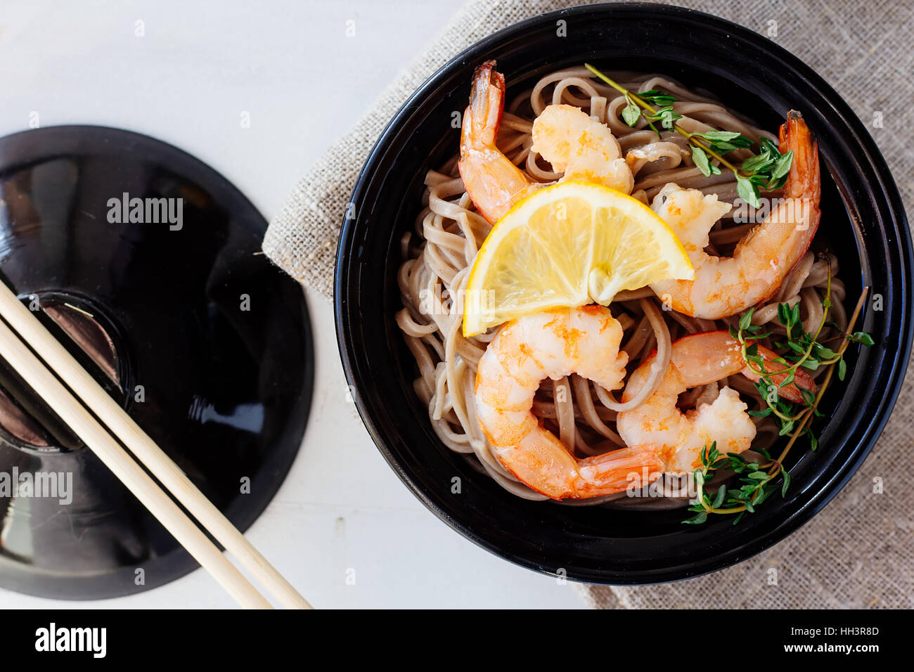Soba with shrimps and herbs top view selective focus Stock Photo
