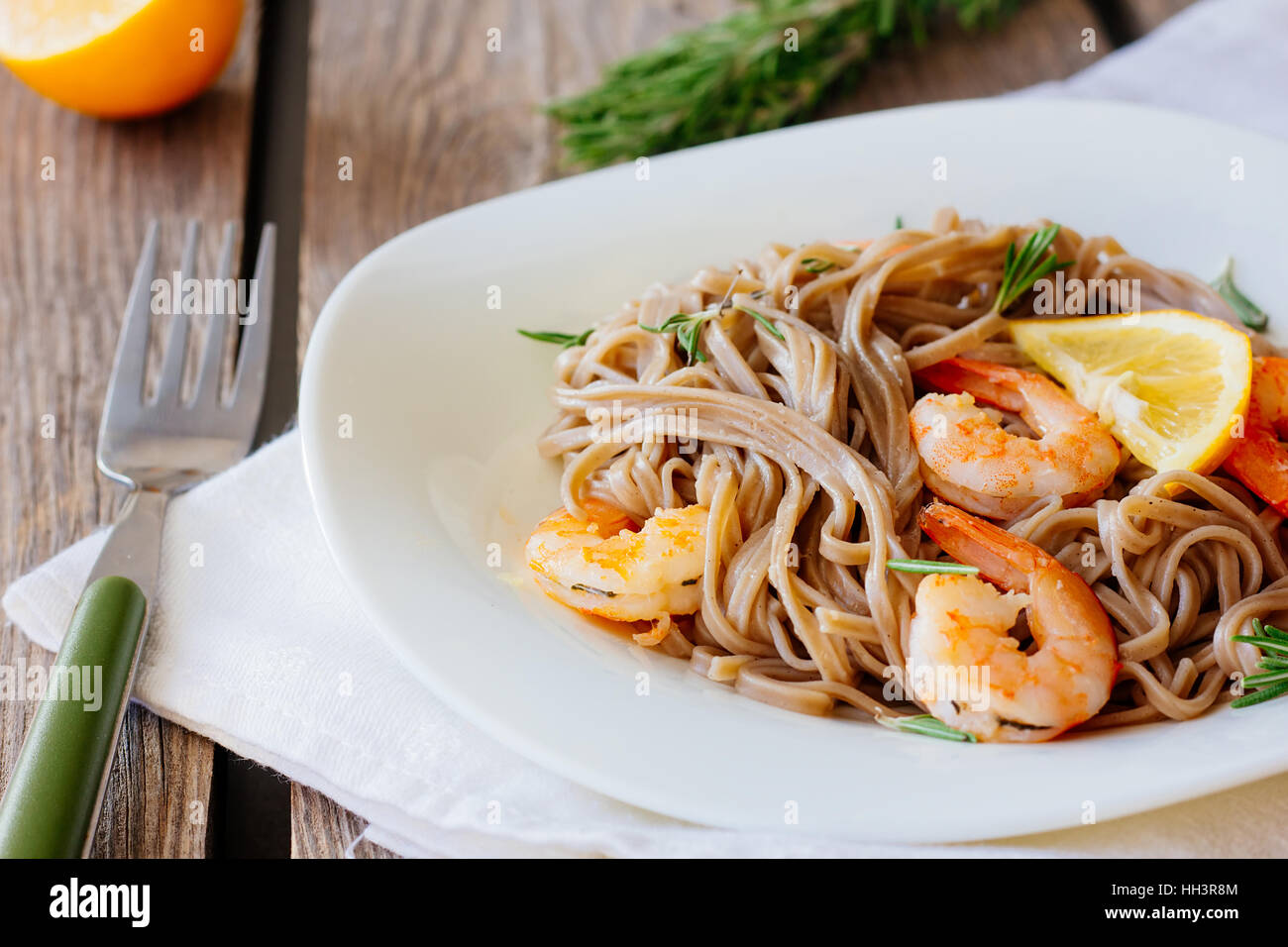 Soba noodles with roasted shrimps on dish selective focus Stock Photo
