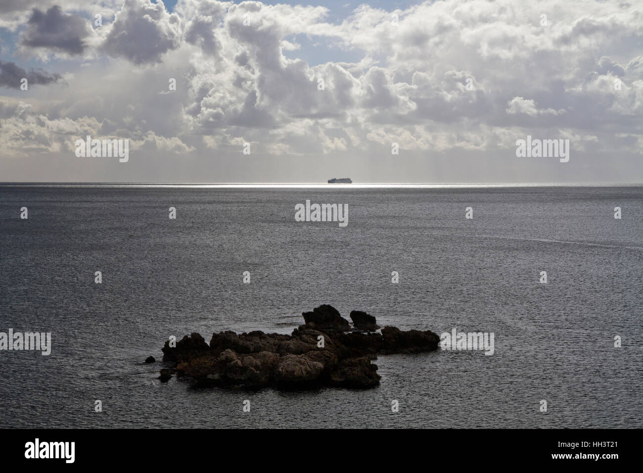 Ferry boat on horizon in Dramatic sea winter cloudy day light scene, Mallorca Spain Stock Photo