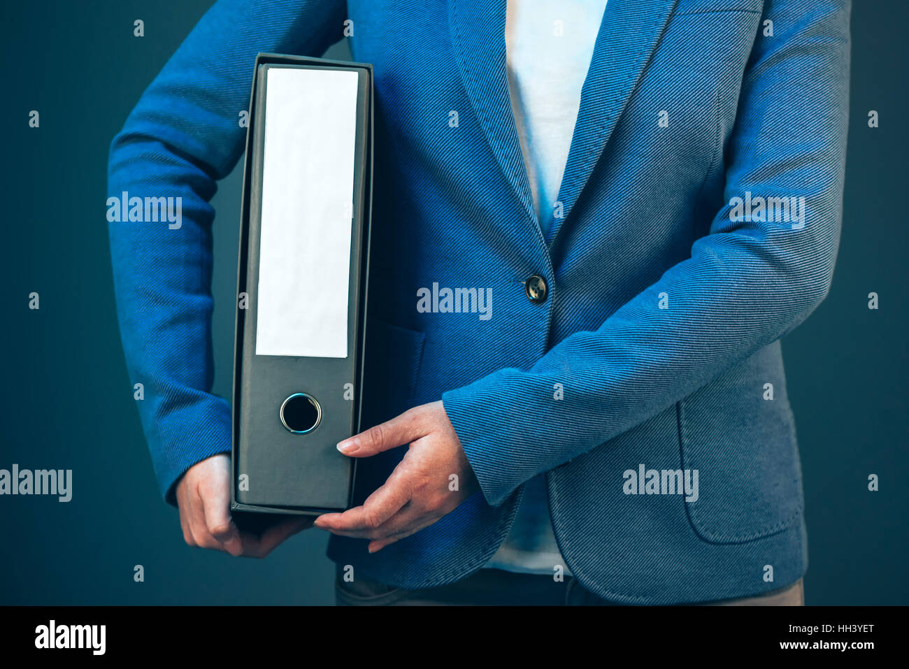 Business woman holding document binder with archived paperwork and