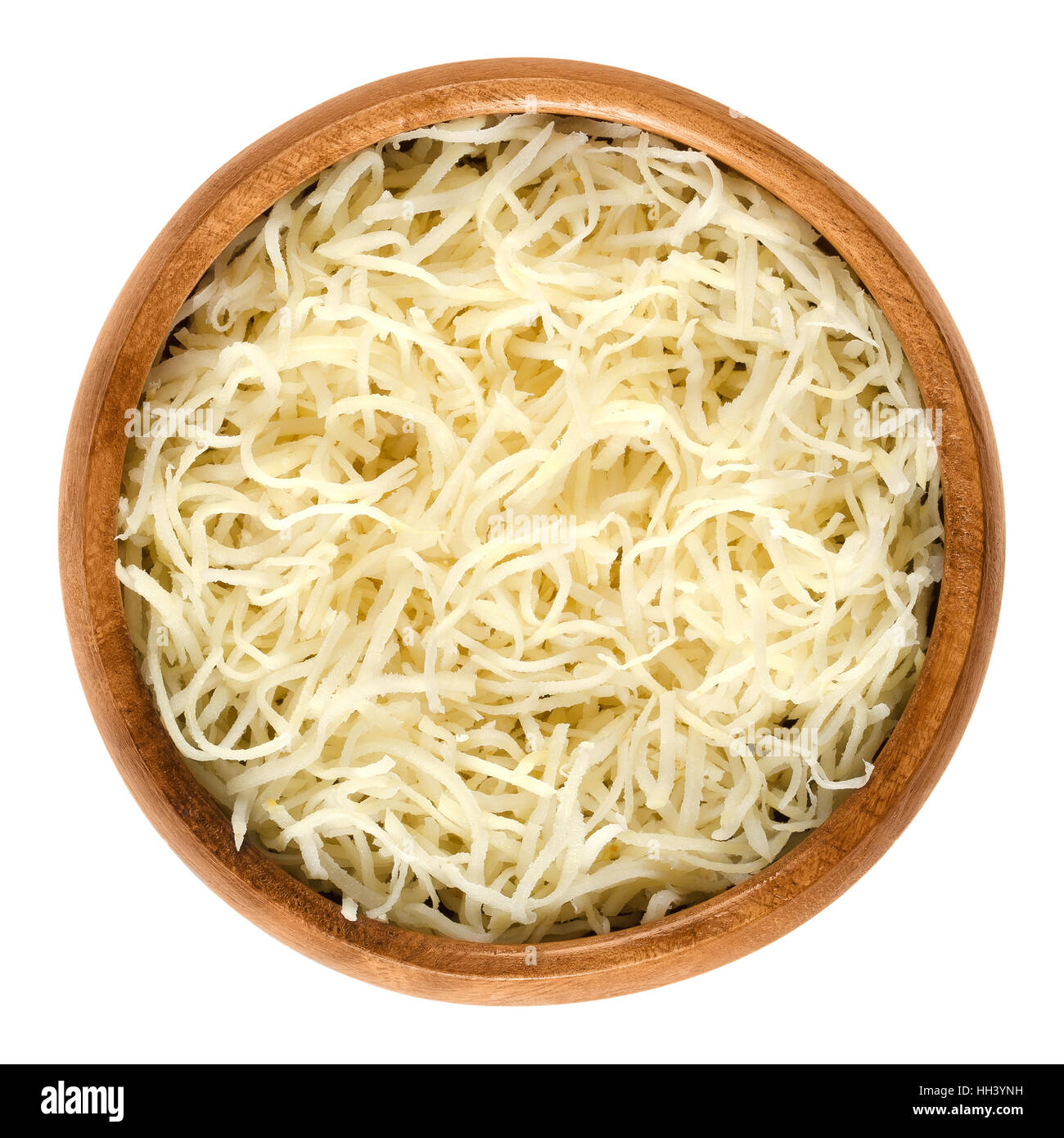 Prepared horseradish in wooden bowl. Grated roots of Armoracia rusticana. Fresh white spice with intense flavor. Stock Photo