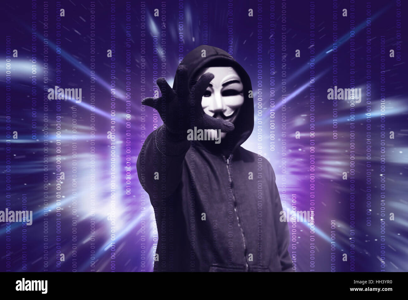 Dangerous hacker with mask want to stealing data over binary code in ...