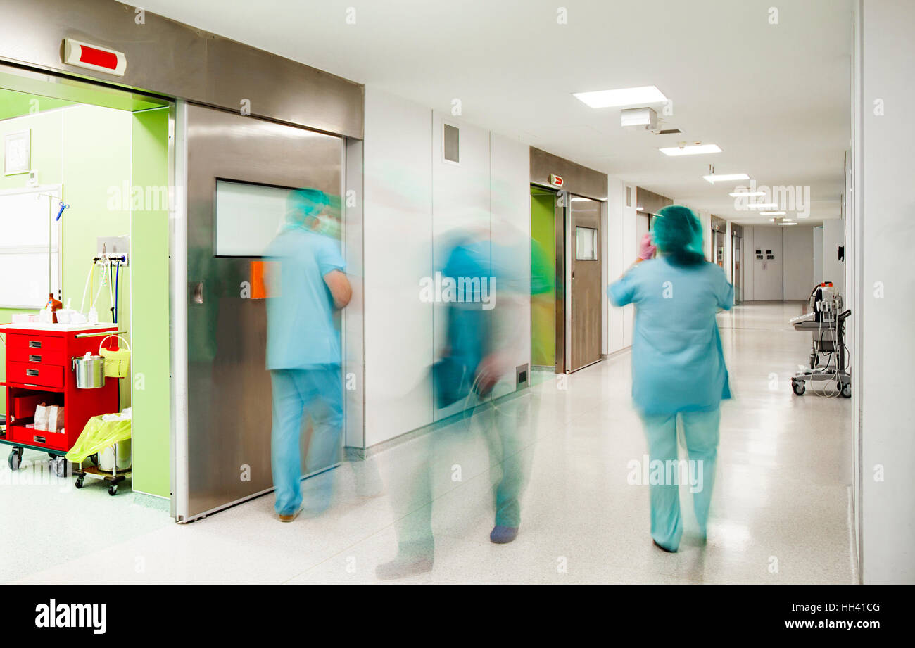 Blurred Figures Of Doctors And Nurse Down The Corridor In