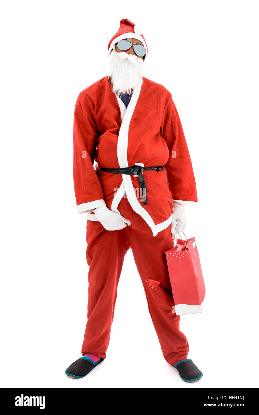 African American Black Thug Gangster Criminal Robber Santa in red costume suit is holding a present bag. Stock Photo
