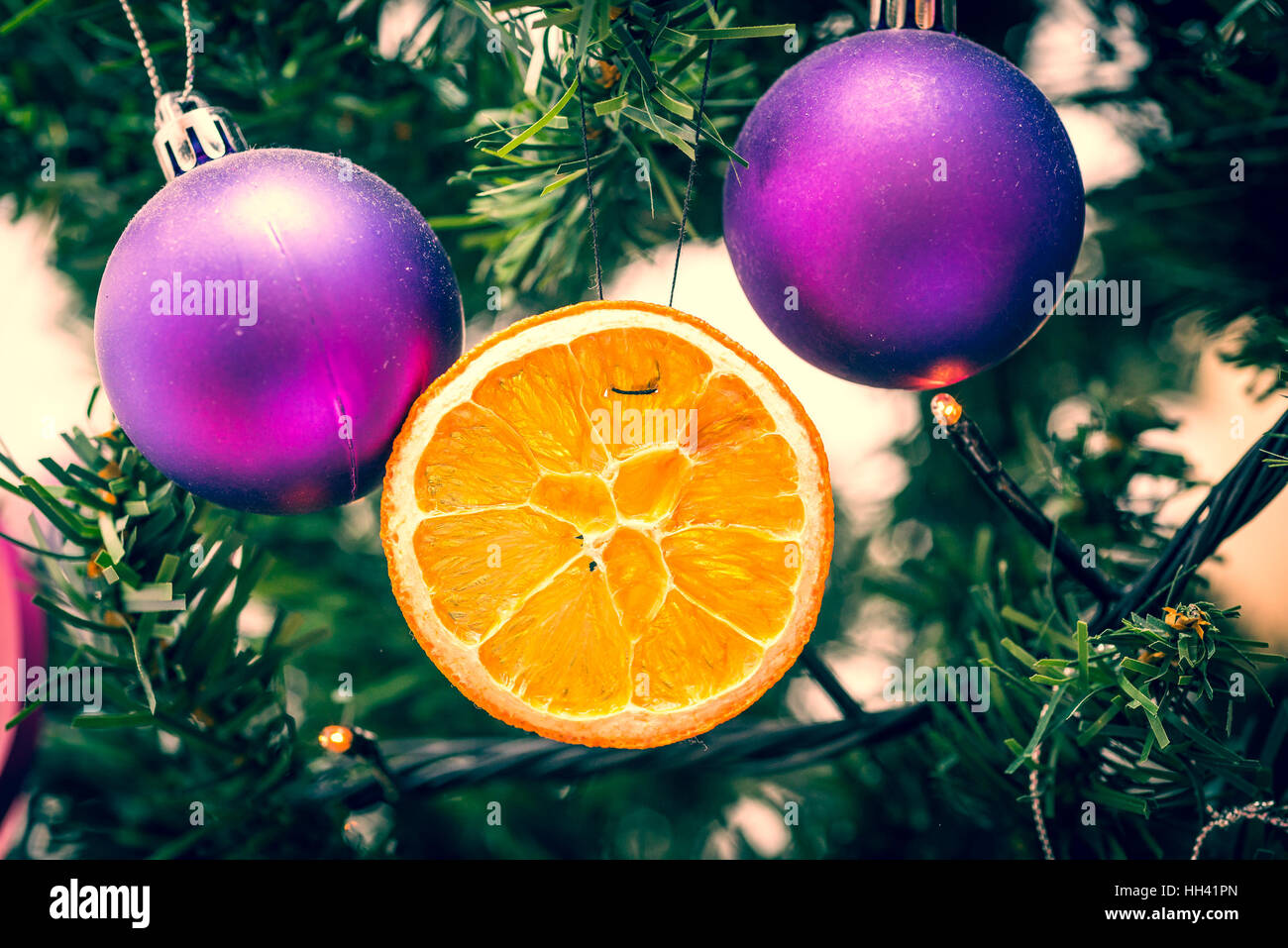 Christmas Ornaments on a green Christmas Tree in retro filter effect or
