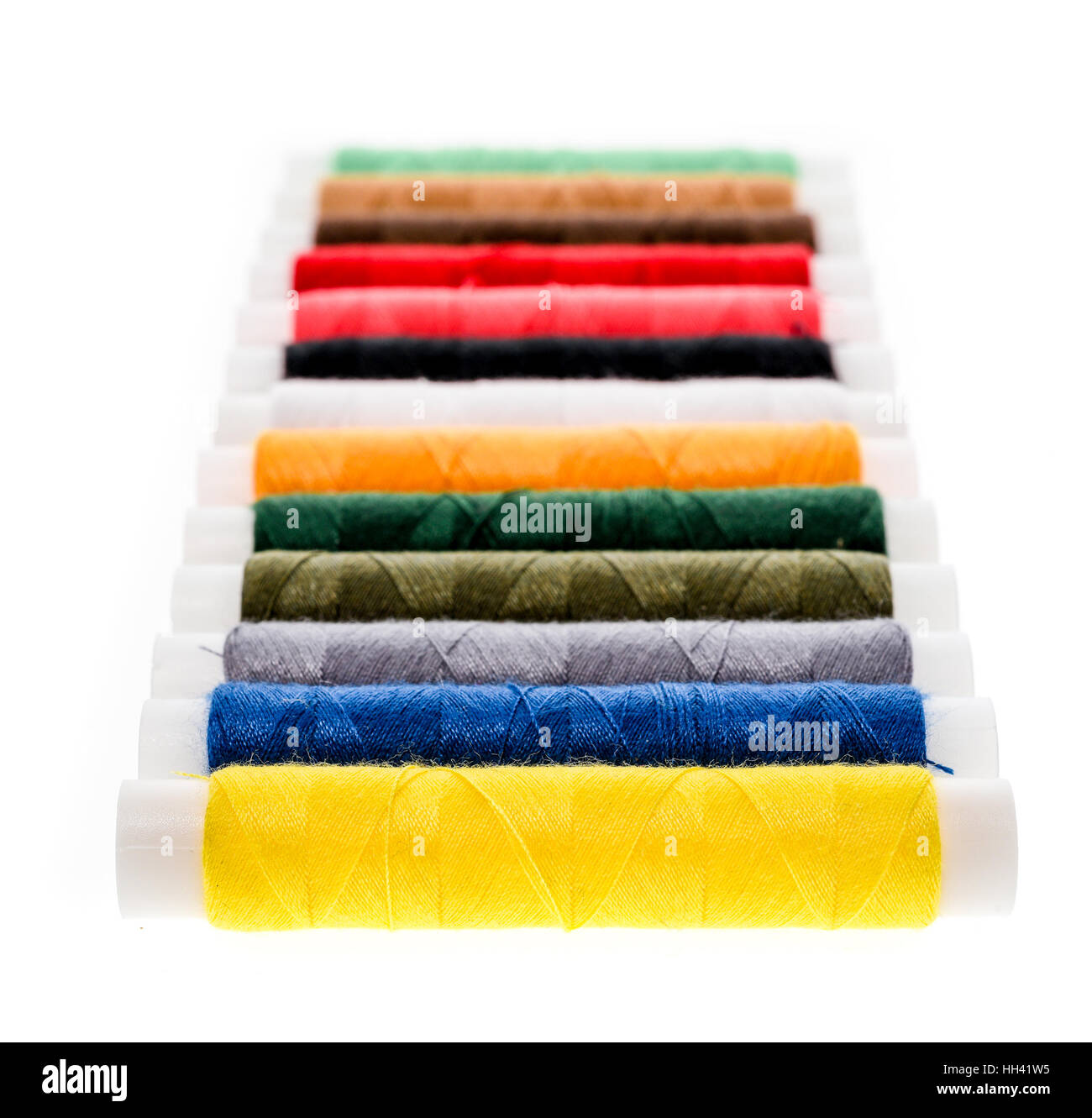 Different color Sewing Threads on a roll. Isolated on white background. Sewing accessories for