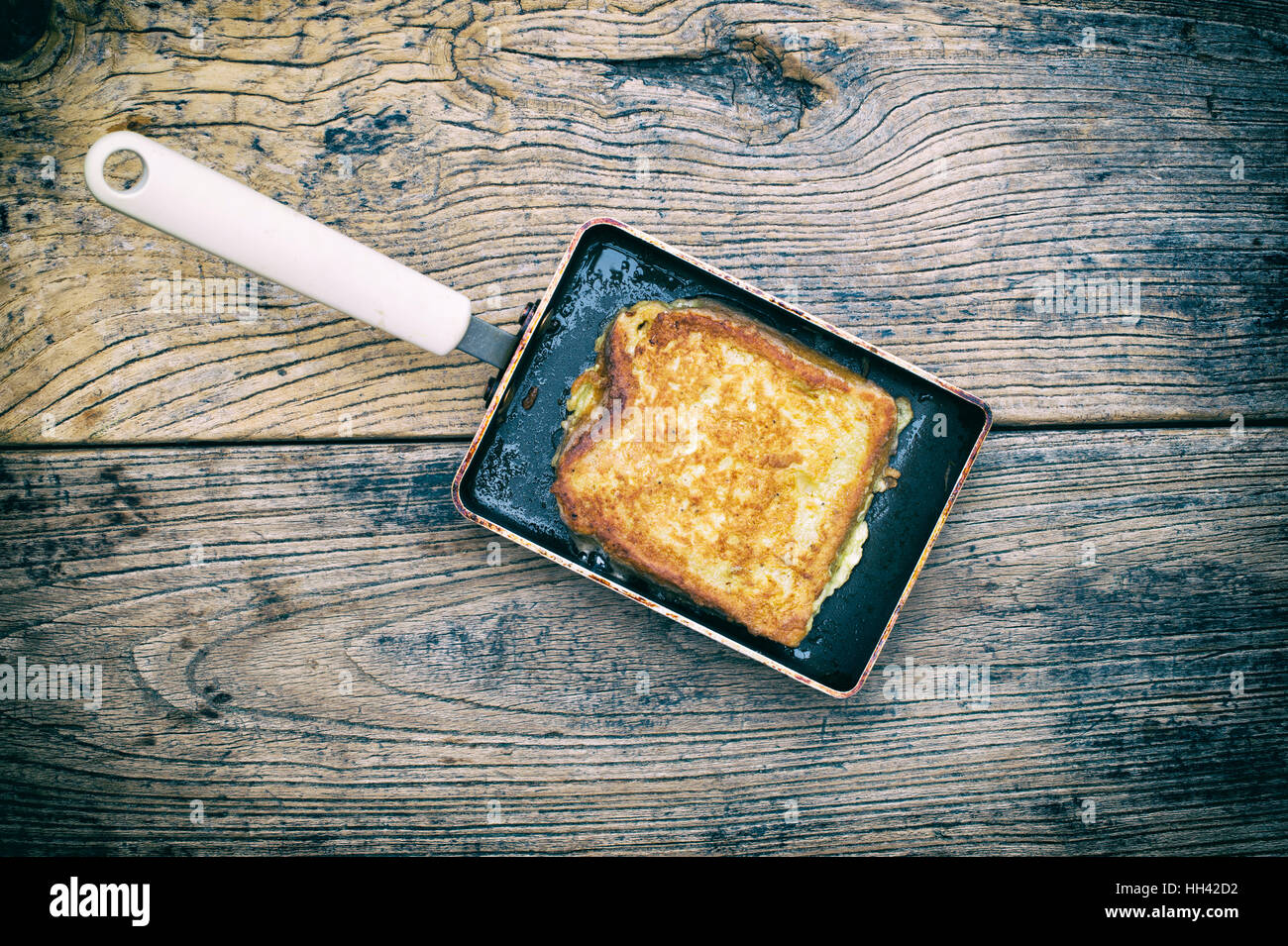 Eggy bread / French Toast in a rectangular frying pan on wood. Vintage