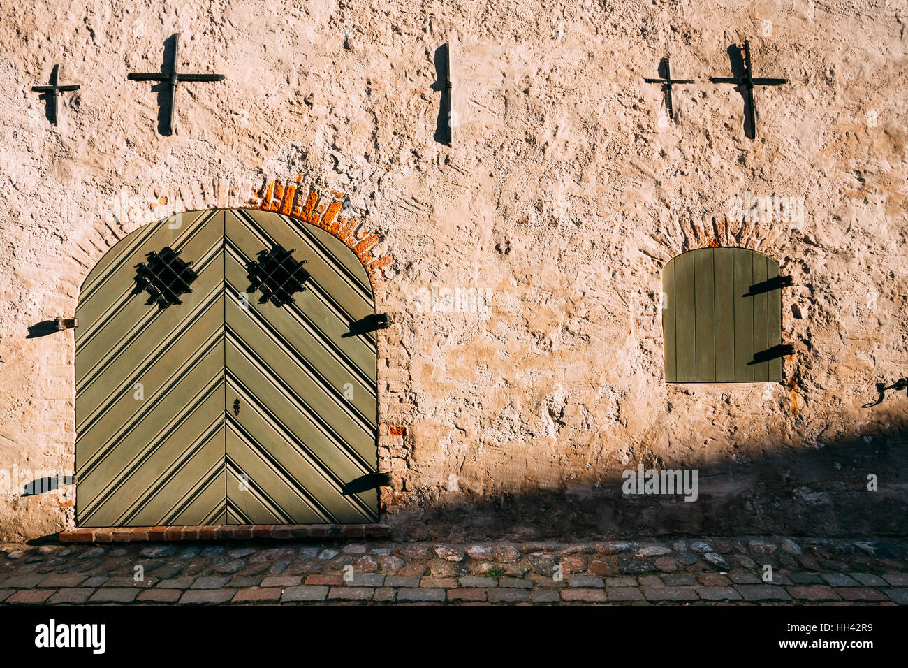 Riga, Latvia. Facade Of Ancient Medieval Building With Big Closed Gate ...