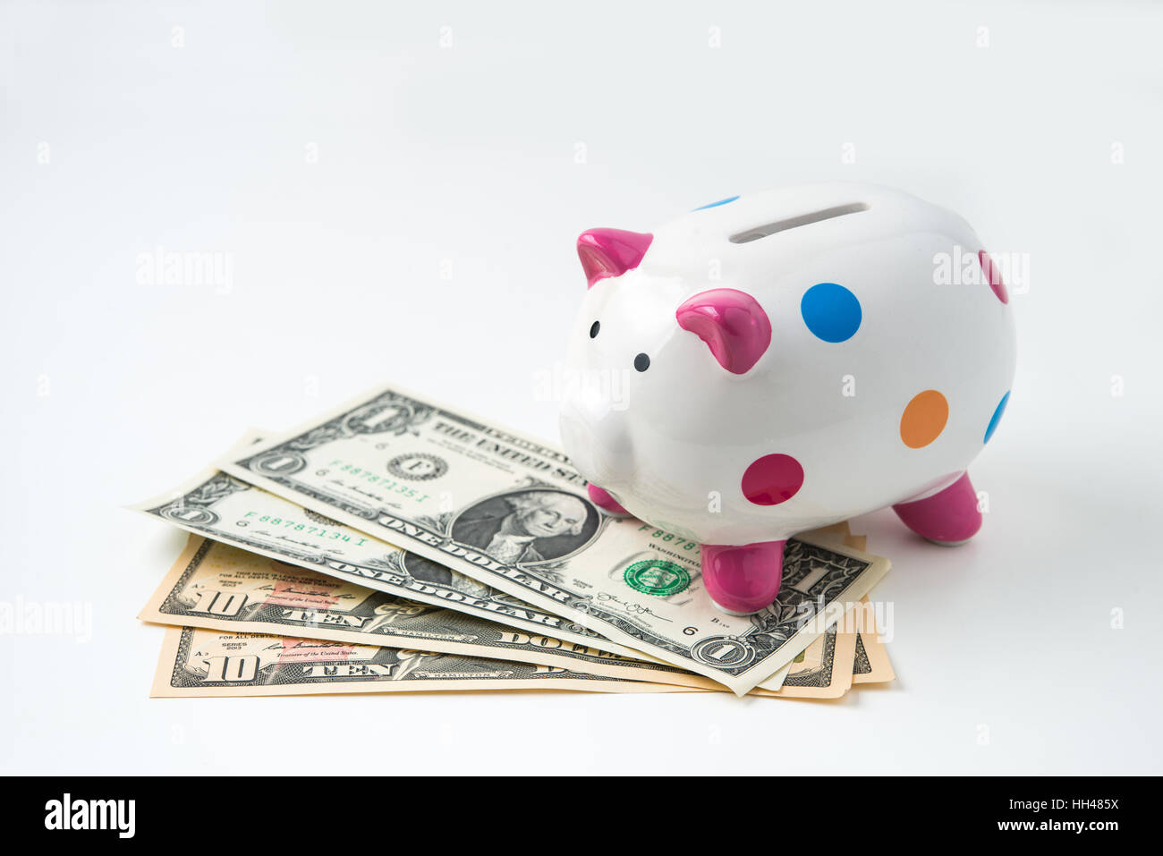 piggy bank with money on white background Stock Photo - Alamy