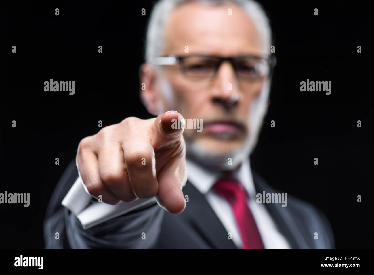 Handsome mature businessman pointing at camera with finger Stock Photo