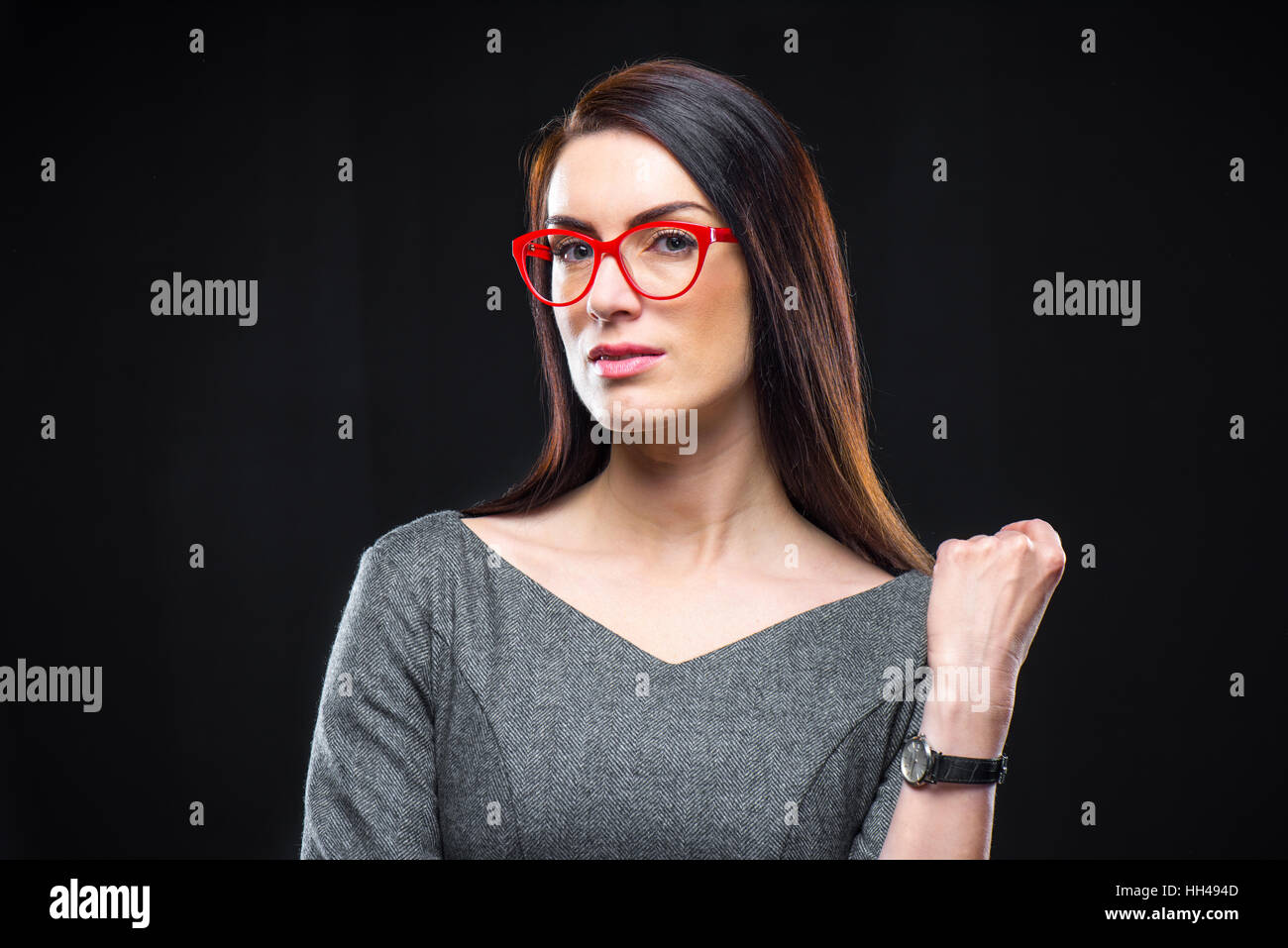 Portrait of pensive young woman in red eyeglasses looking at camera Stock Photo