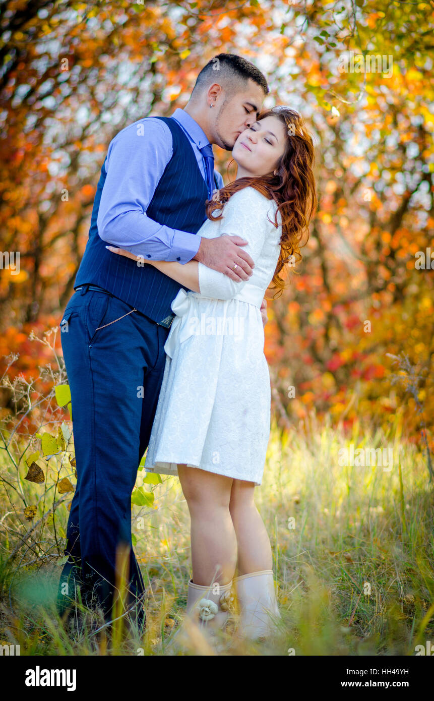 Young couple embracing on nature background. Wedding. Love Stock Photo -  Alamy