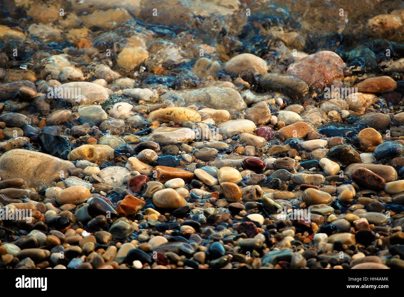 Colorful Pebbles in a Stream Stock Photo