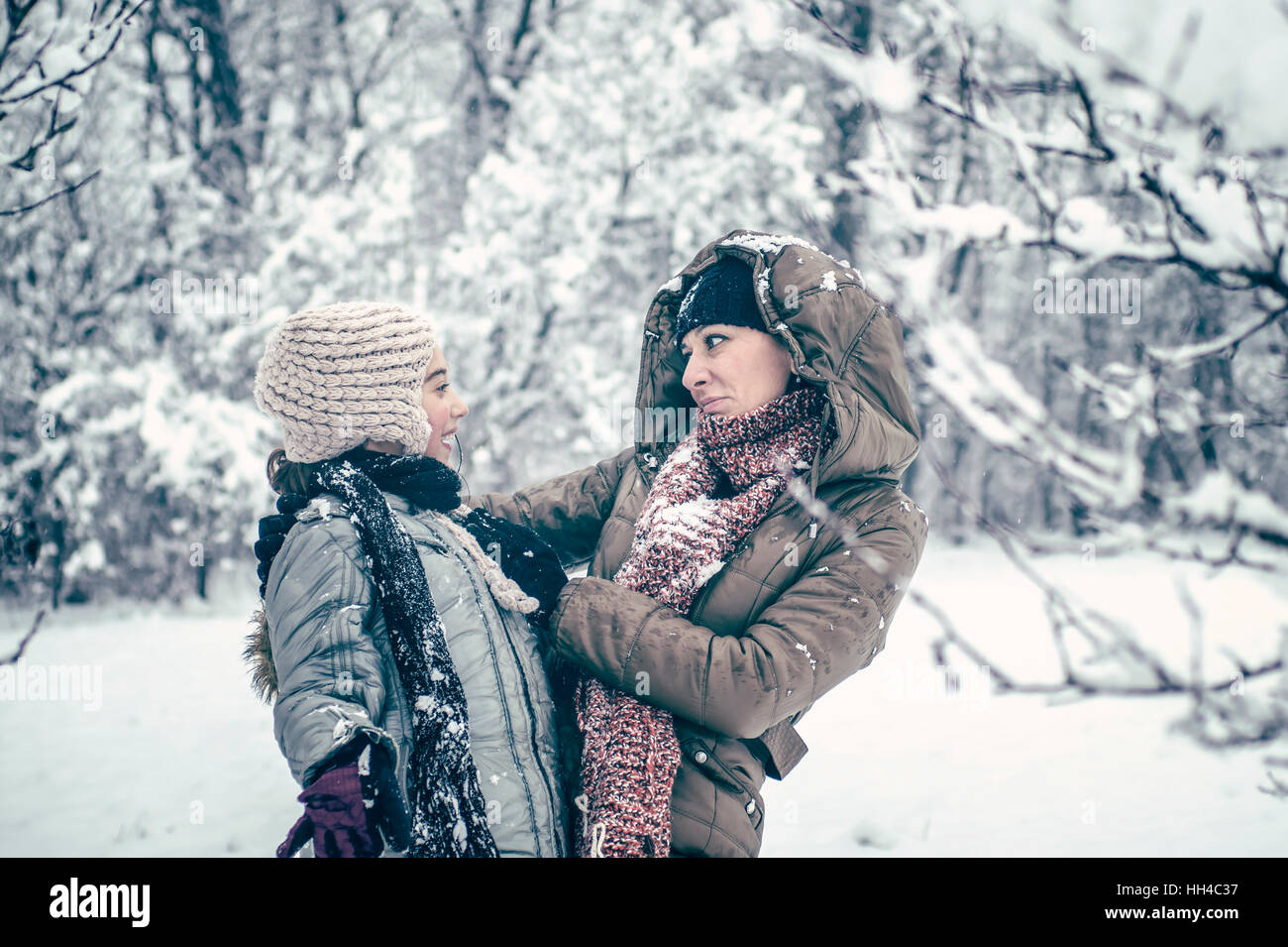 Mother and her daughter enjoying winter day outdoors, retro look Stock Photo