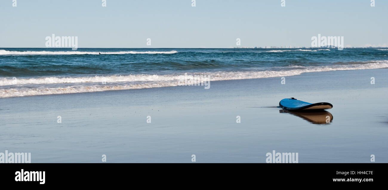 Surf board on a desert foreshore Stock Photo