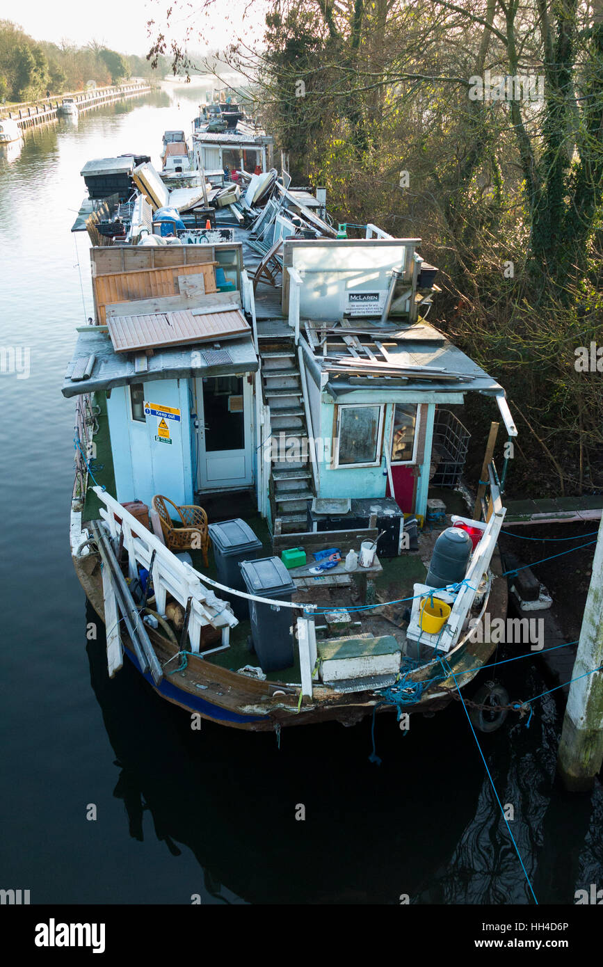 Popularly described as a ' slum ' boat, house boats are pictured moored at Teddington Lock, on the River Thames. West London. UK Stock Photo