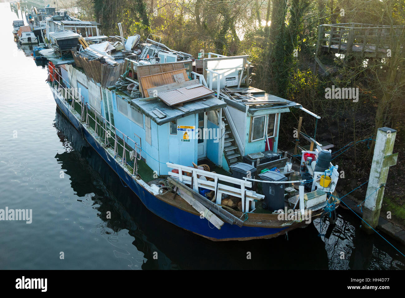 Popularly described as a ' slum ' boat, house boats are pictured moored at Teddington Lock, on the River Thames. West London. UK Stock Photo