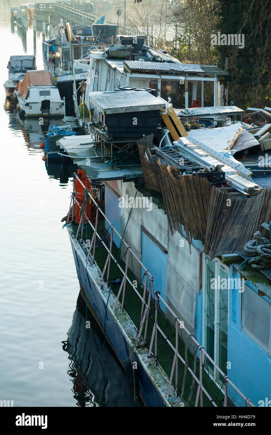 Popularly described as a ' slum ' boat, house boats are pictured moored at Teddington Lock, on the River Thames. West London. UK Stock Photo