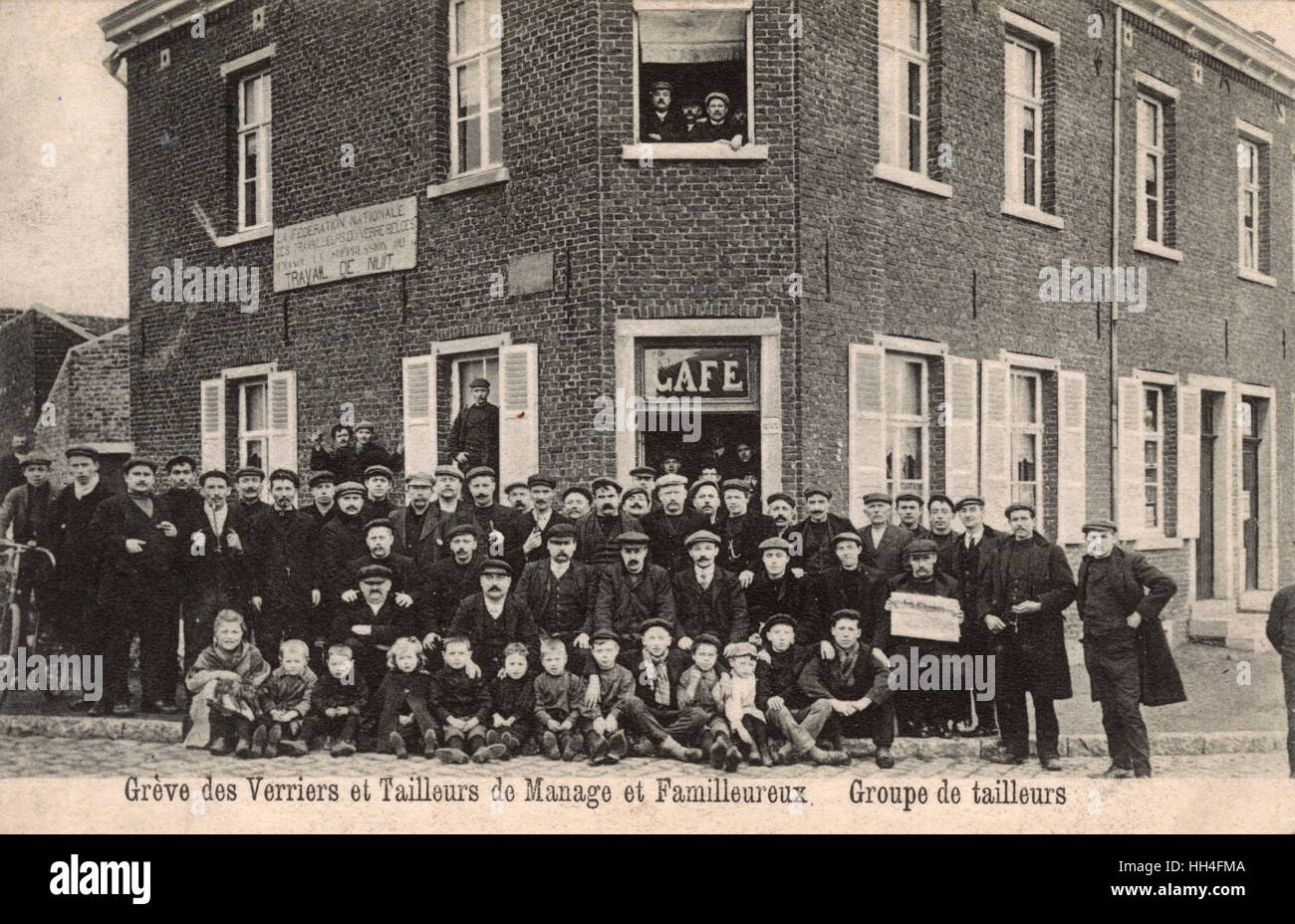 A strike by Belgian Glassmakers and Engravers / Cutters from the Glassworks at Manage,  Hainaut, Belgium - the board notice on the building behind them demands an end to having to work throughout the day and the night. A large group of Glass Cutters, incl Stock Photo