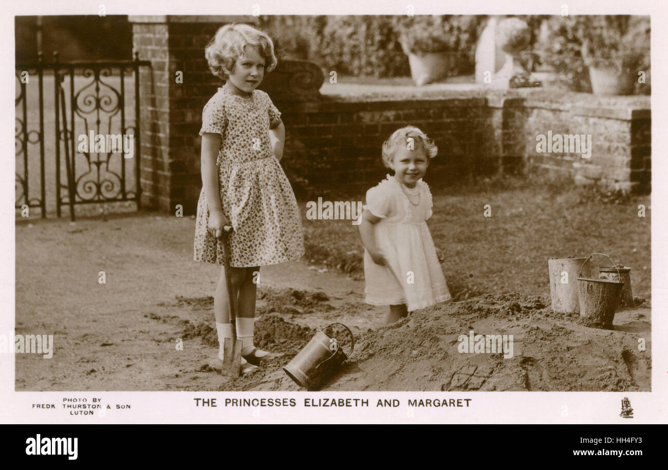 Princesses Elizabeth (1926-) (later Queen Elizabeth II) and Margaret (1930-2002) playing in the sandpit at St. Paul's Walden Bury, Welyn, Herts - the residence of their grandparents Claude Bowes-Lyon, 14th Earl of Strathmore and Kinghorne and Cecilia Cave Stock Photo