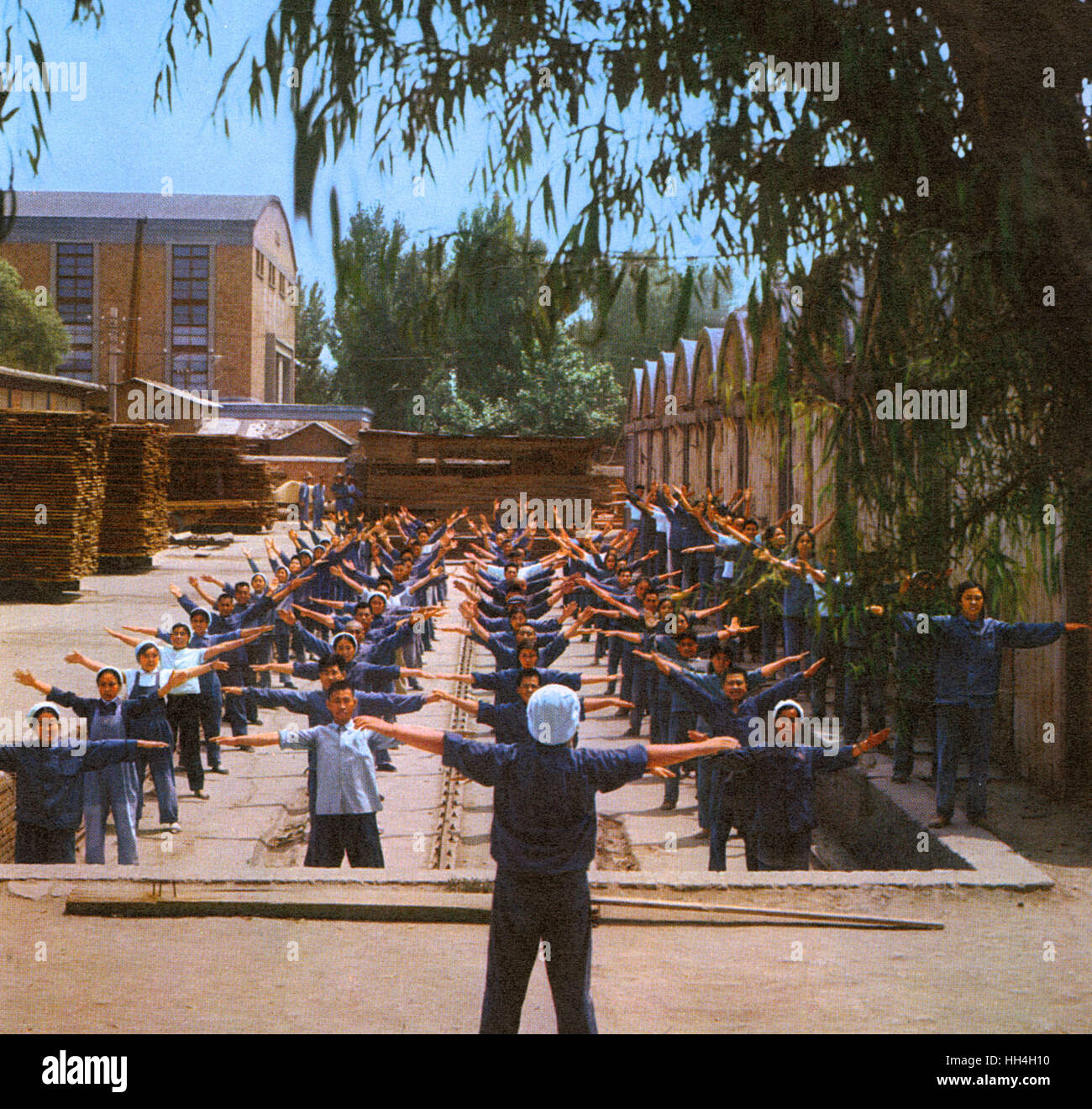 Communal exercise session for timberyard workers during the Cultural Revolution era in Communist China. Stock Photo