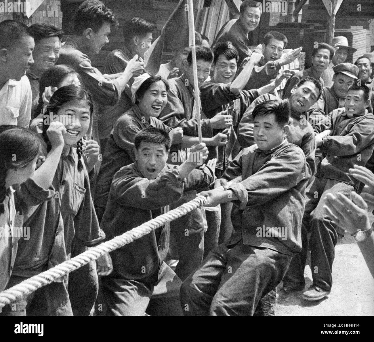 Workers having fun taking part in a tug of war session during the Cultural Revolution era in Communist China. Stock Photo