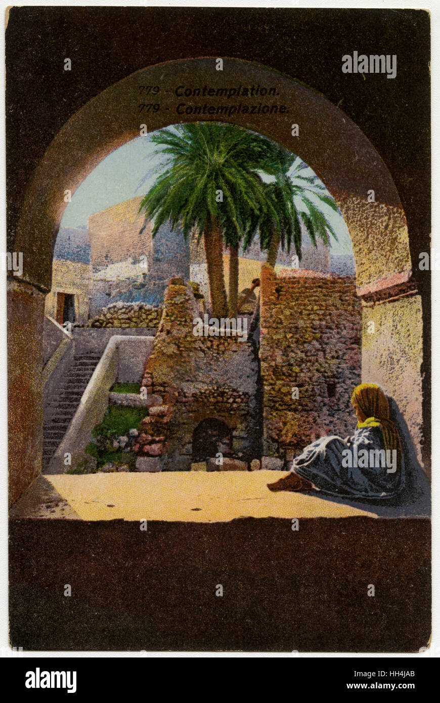 Contemplation - Young child sits beneath an arch - Tunisia Stock Photo