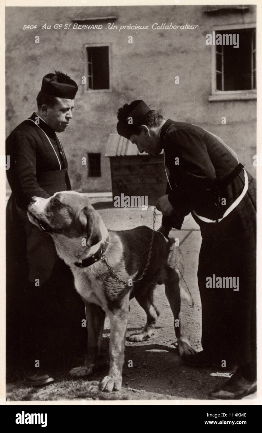 A Saint Bernard rescue dog with two priests, Switzerland Stock Photo