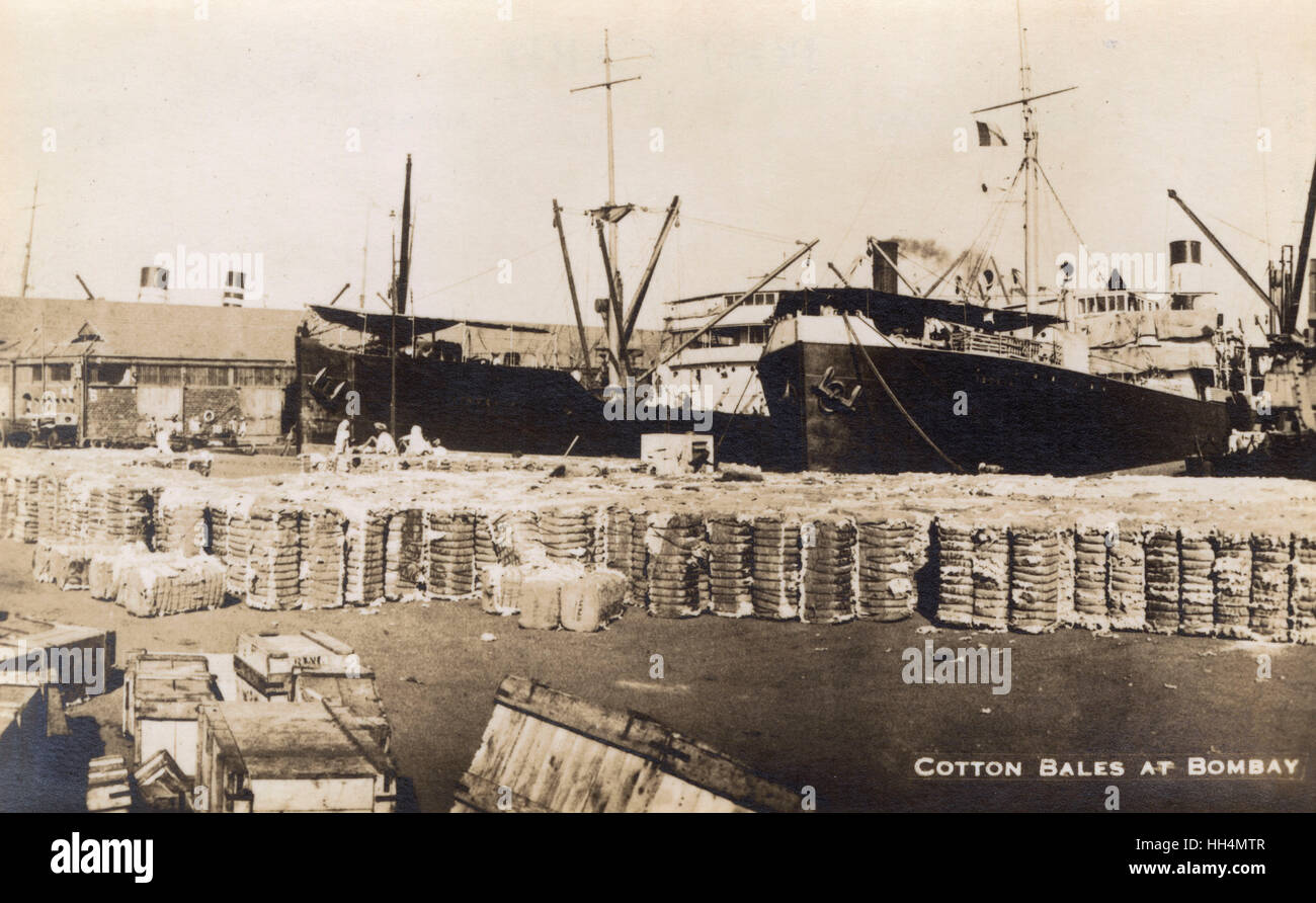Victoria Dock, Bombay (Mumbai), India, with cotton bales piled up on the wharf, and two steamships, the SS Vindella (left) and the SS Ischia (right). Stock Photo