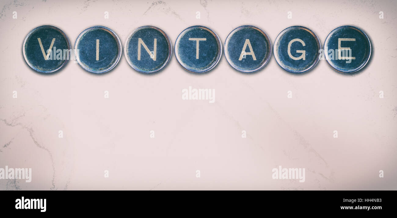 Vintage word made with printer keys on the beige background. Horizontal
