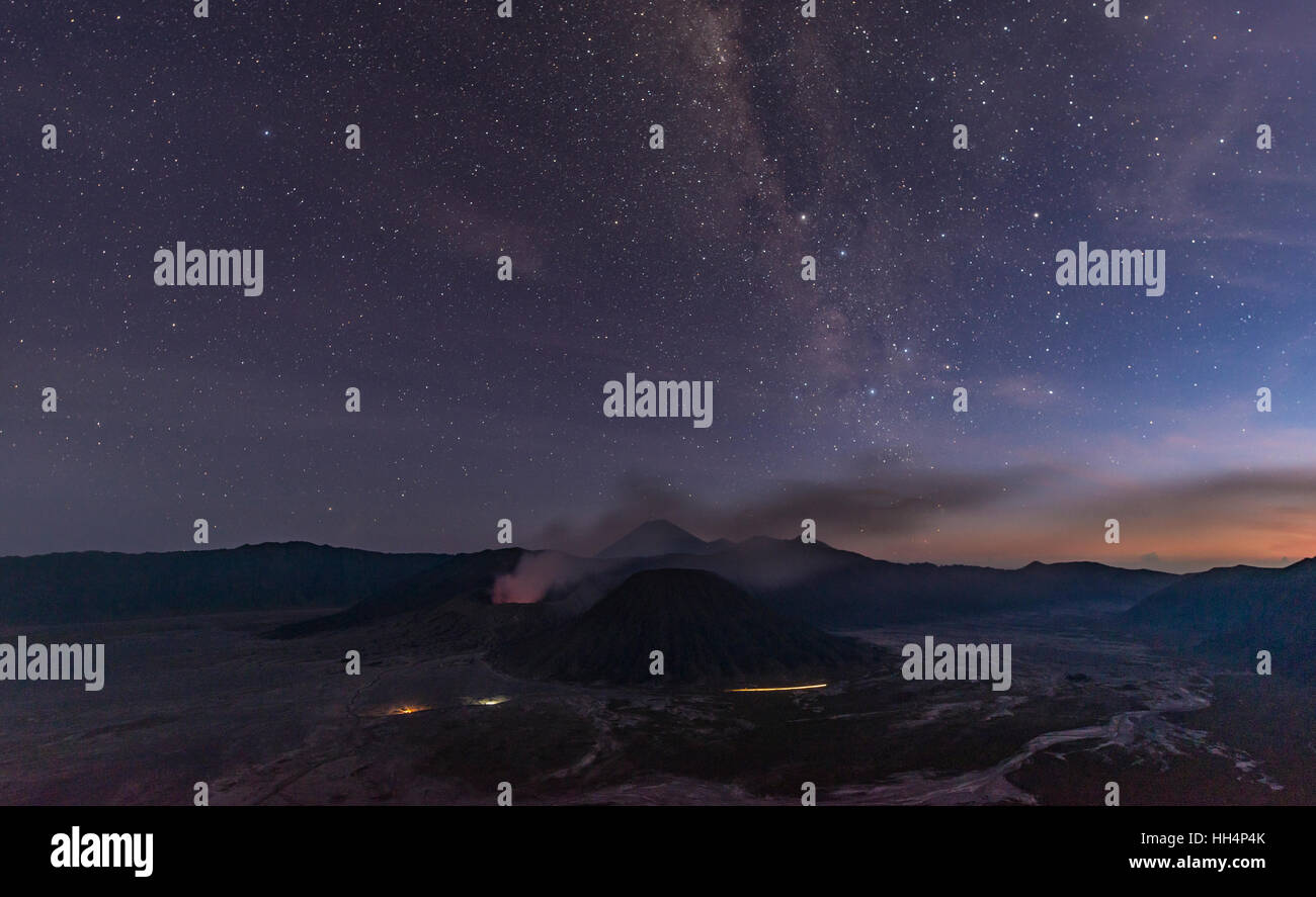 Night sky with stars, smoking volcano Mount Gunung Bromo, Mount Batok in front, Mount Kursi at back, Mount Gunung Semeru, Bromo Stock Photo