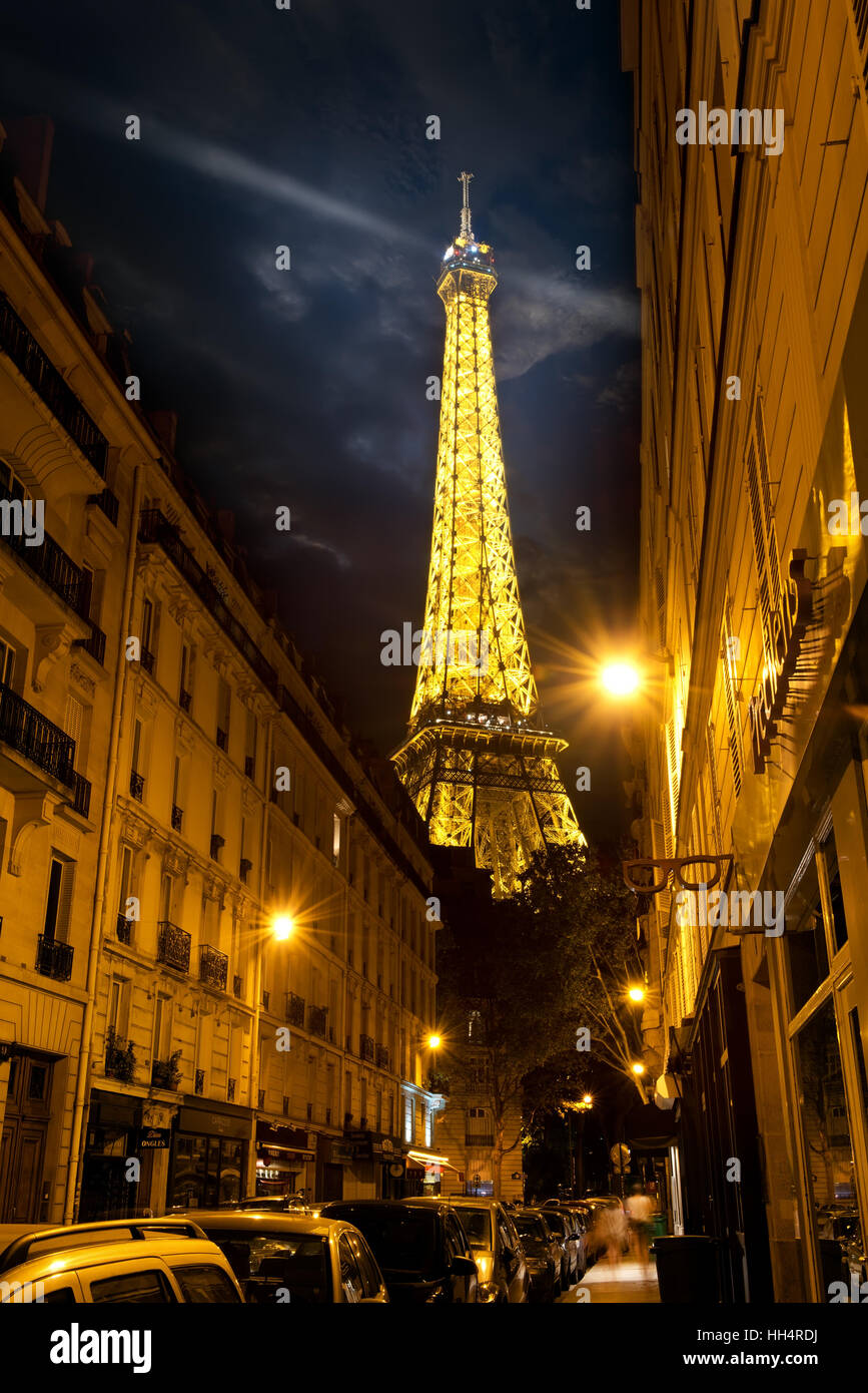 PARIS, FRANCE - AUGUST 25, 2016 : View on illuminated Eiffel Tower from Parisian street in the evening, France Stock Photo