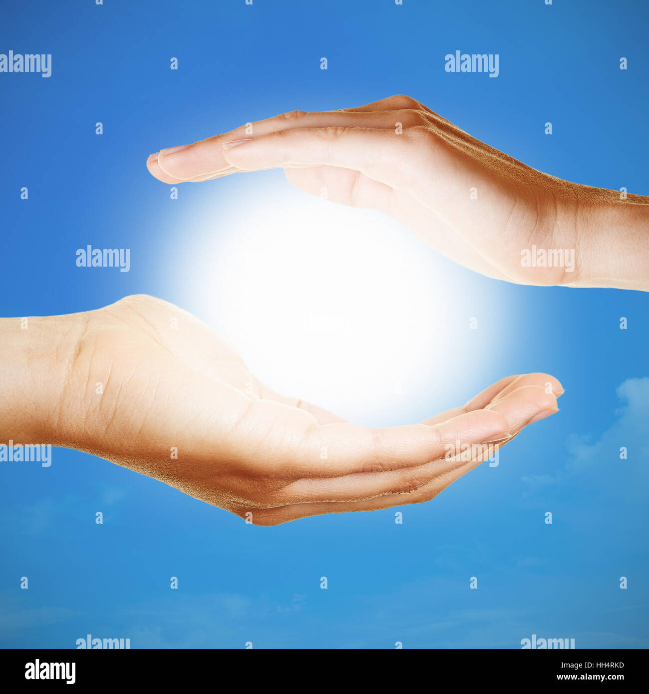 Two hands holding the shiny sun as meditation concept Stock Photo