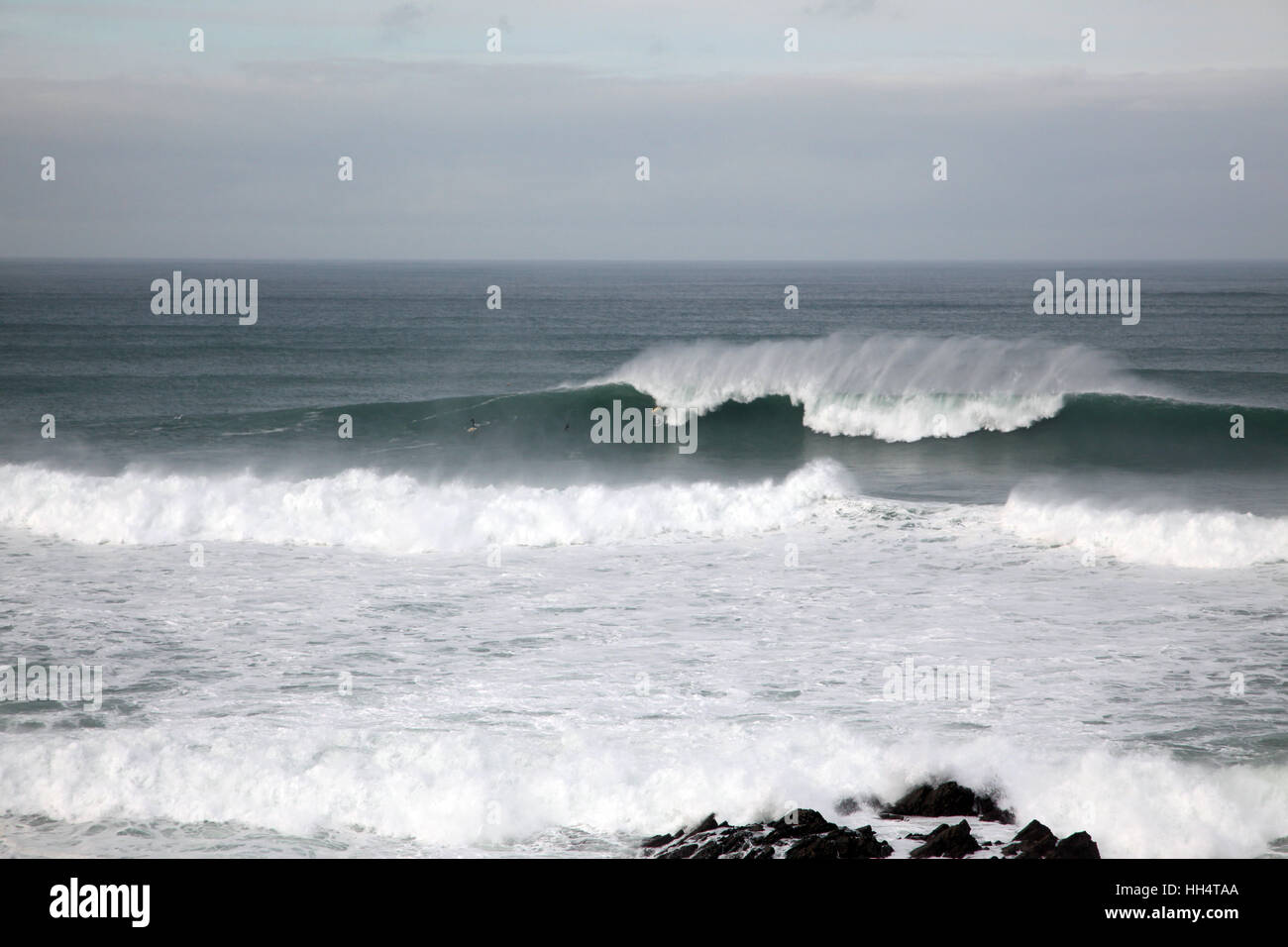 Surfers ride the Cribbar wave reaching heights of 25ft in Newquay