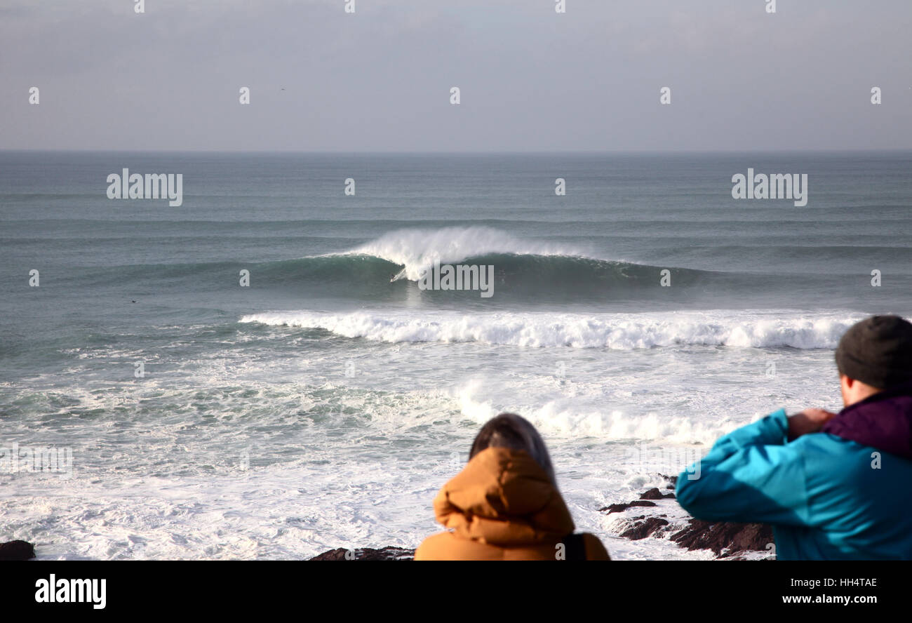Surfers ride the Cribbar wave reaching heights of 25ft in Newquay