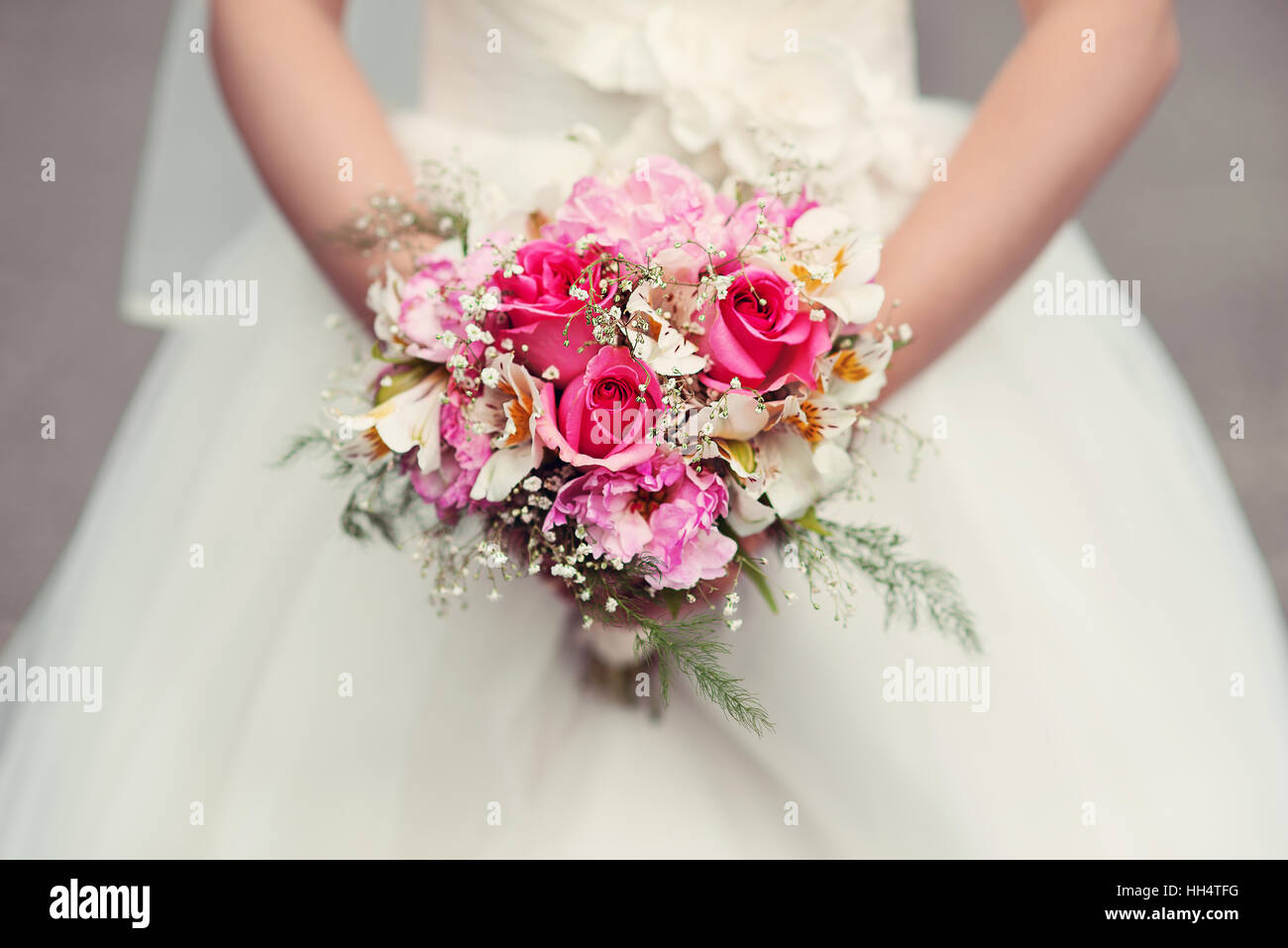 Bride holding her wedding bouquet with roses Stock Photo - Alamy