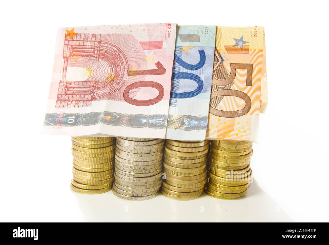 Money house - House shap with bank notes and coins Stock Photo - Alamy