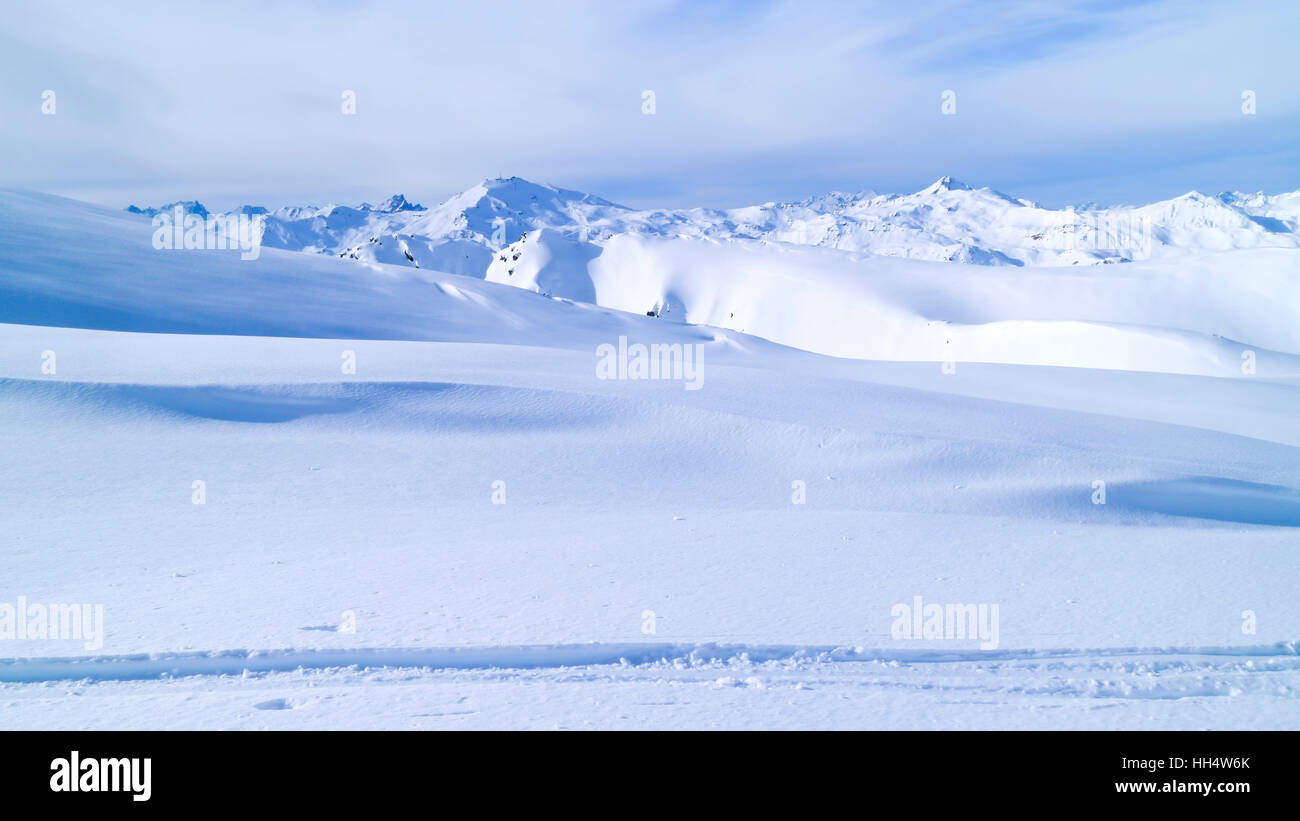 Winter mountain panorama with fresh snow on skiing tracks, Val Thorens slopes, Alps, France Stock Photo