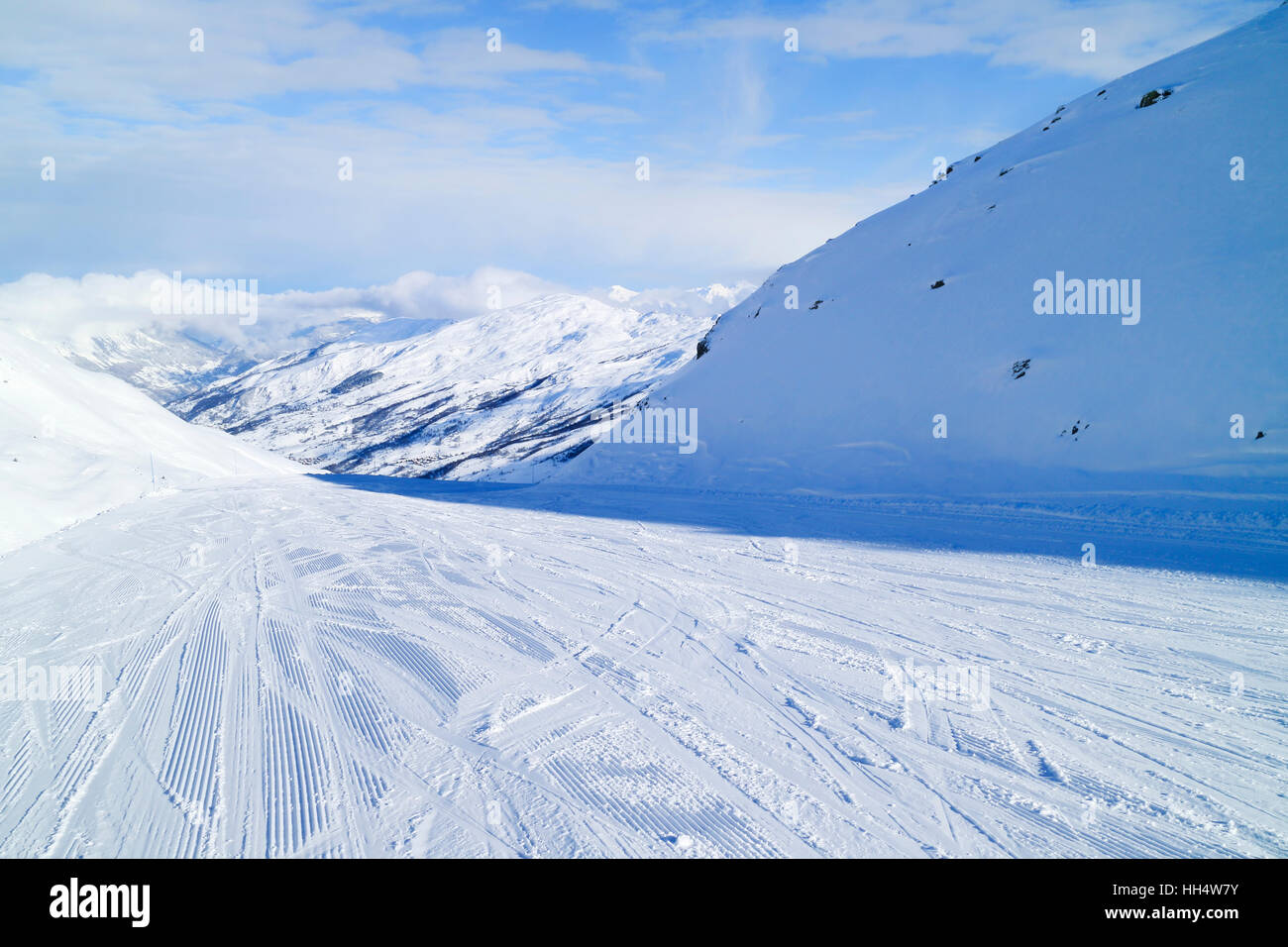 On downhill skiing slope towards Val Thorens in 3 Valleys winter resort, France Stock Photo