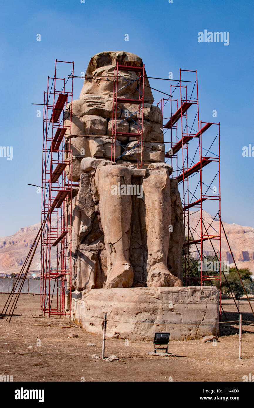 Colossi of Memnon are two massive stone statues of the Pharaoh Amenhotep III, who reigned in Egypt during Dynasty under repair. Stock Photo