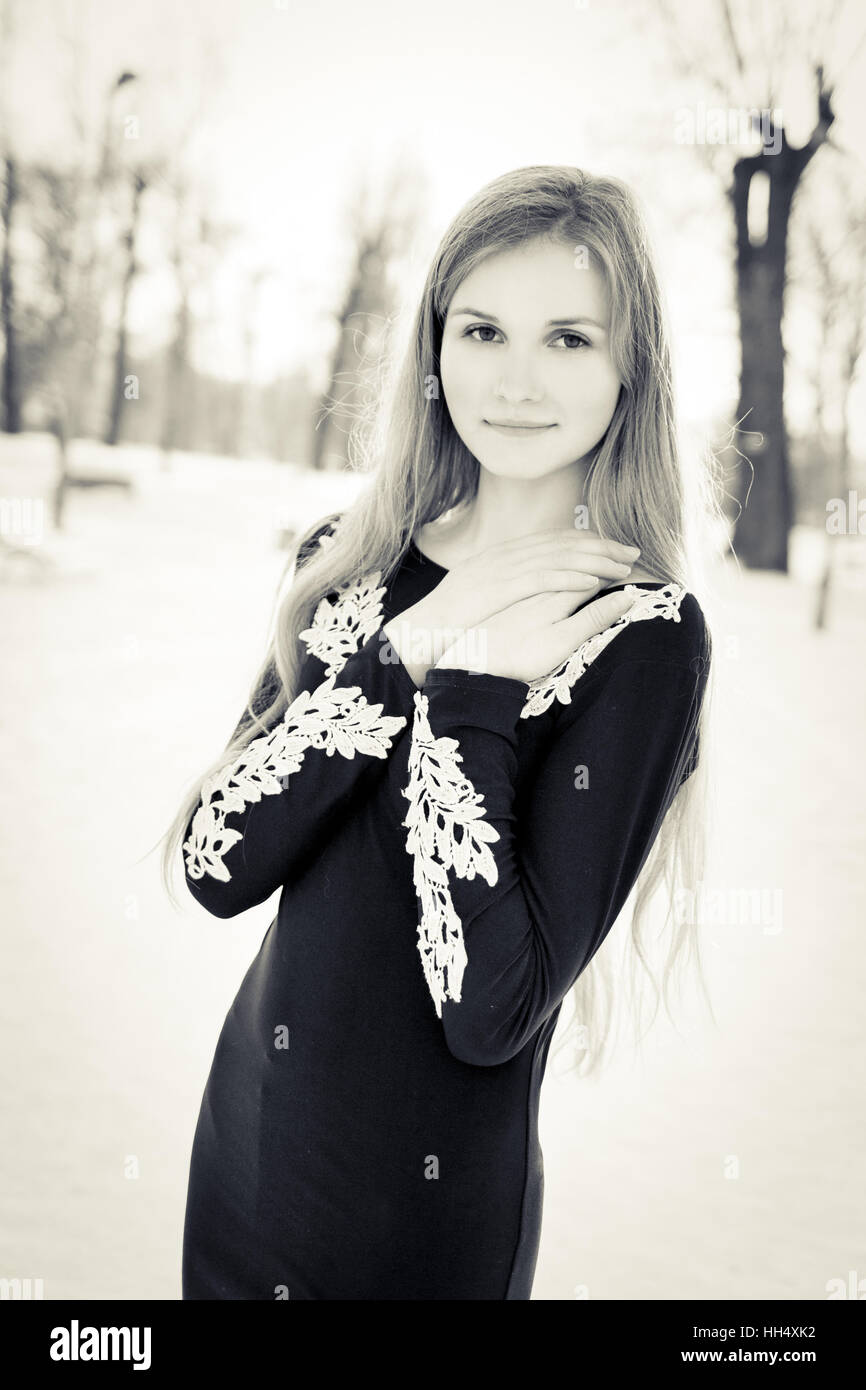 Young girl with long hair in black dress Stock Photo - Alamy