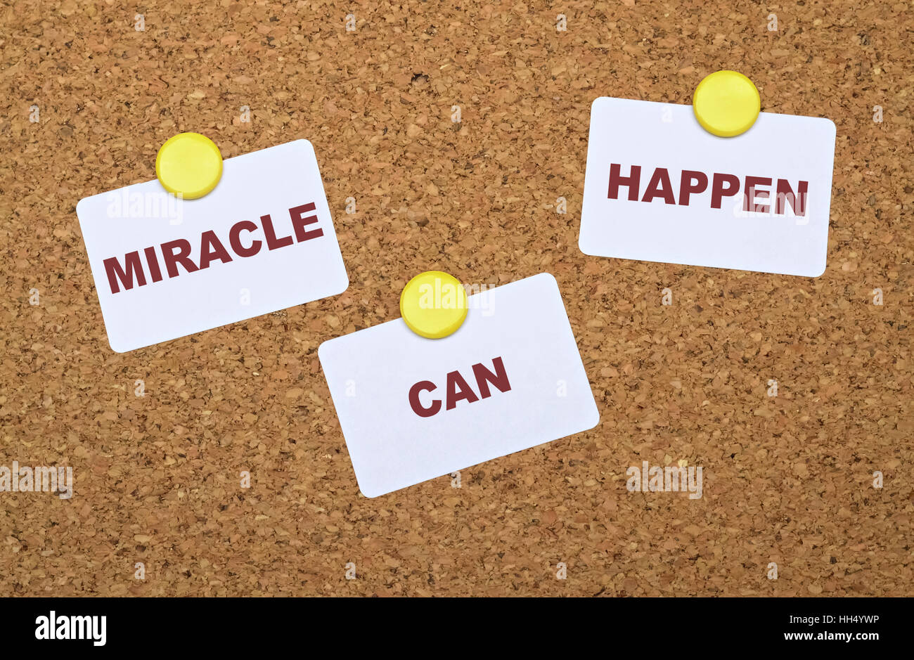 Text Miracle Can Happen on white stickers pinned on cork board Stock Photo