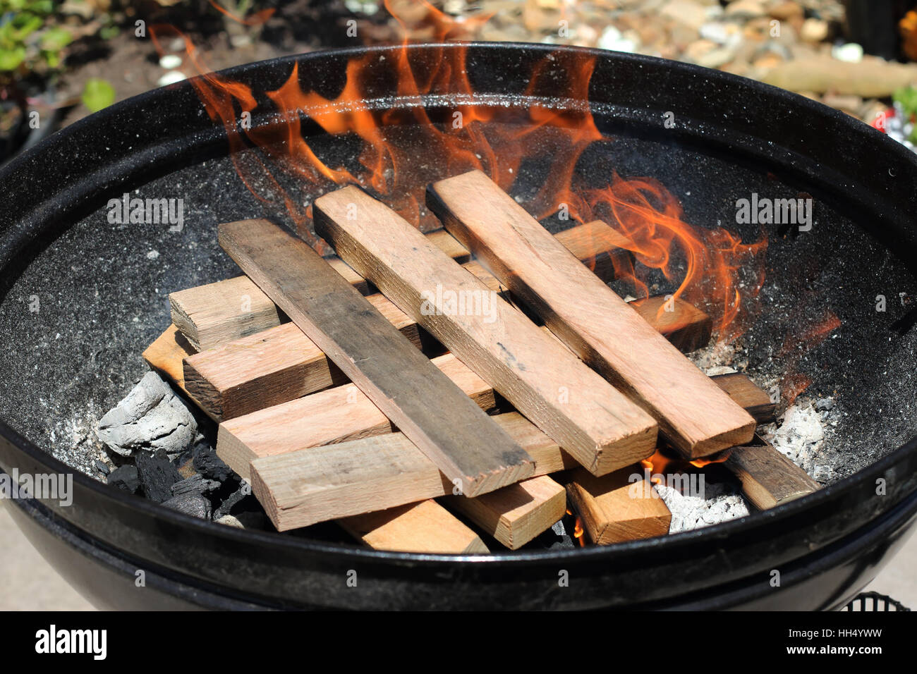 Burning kindling in portable barbecue Stock Photo Alamy