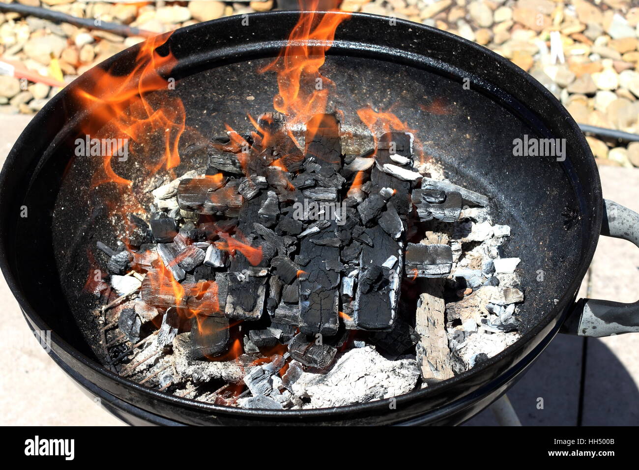Burning kindling in portable barbecue Stock Photo Alamy