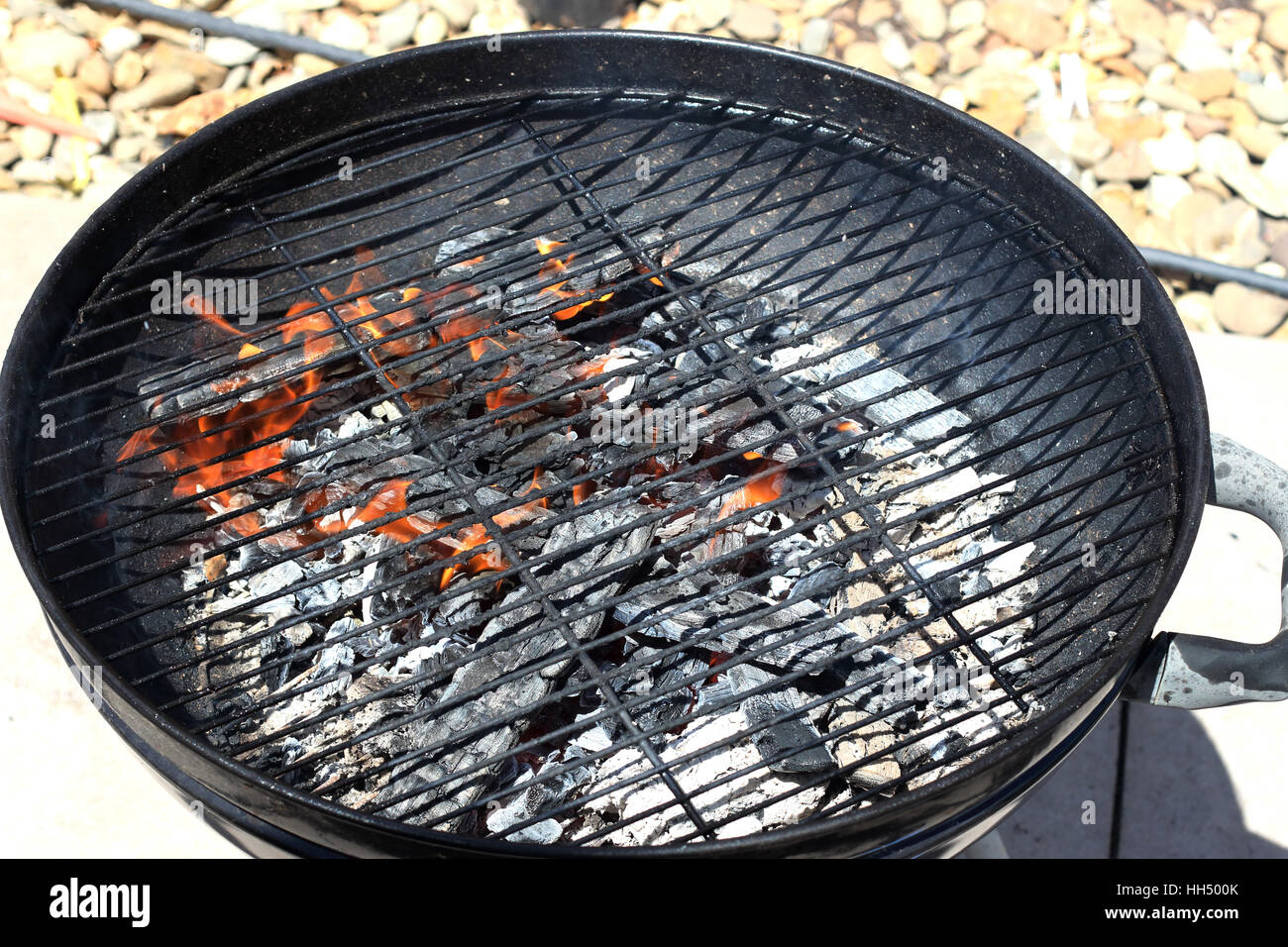 Burning kindling in portable barbecue Stock Photo Alamy