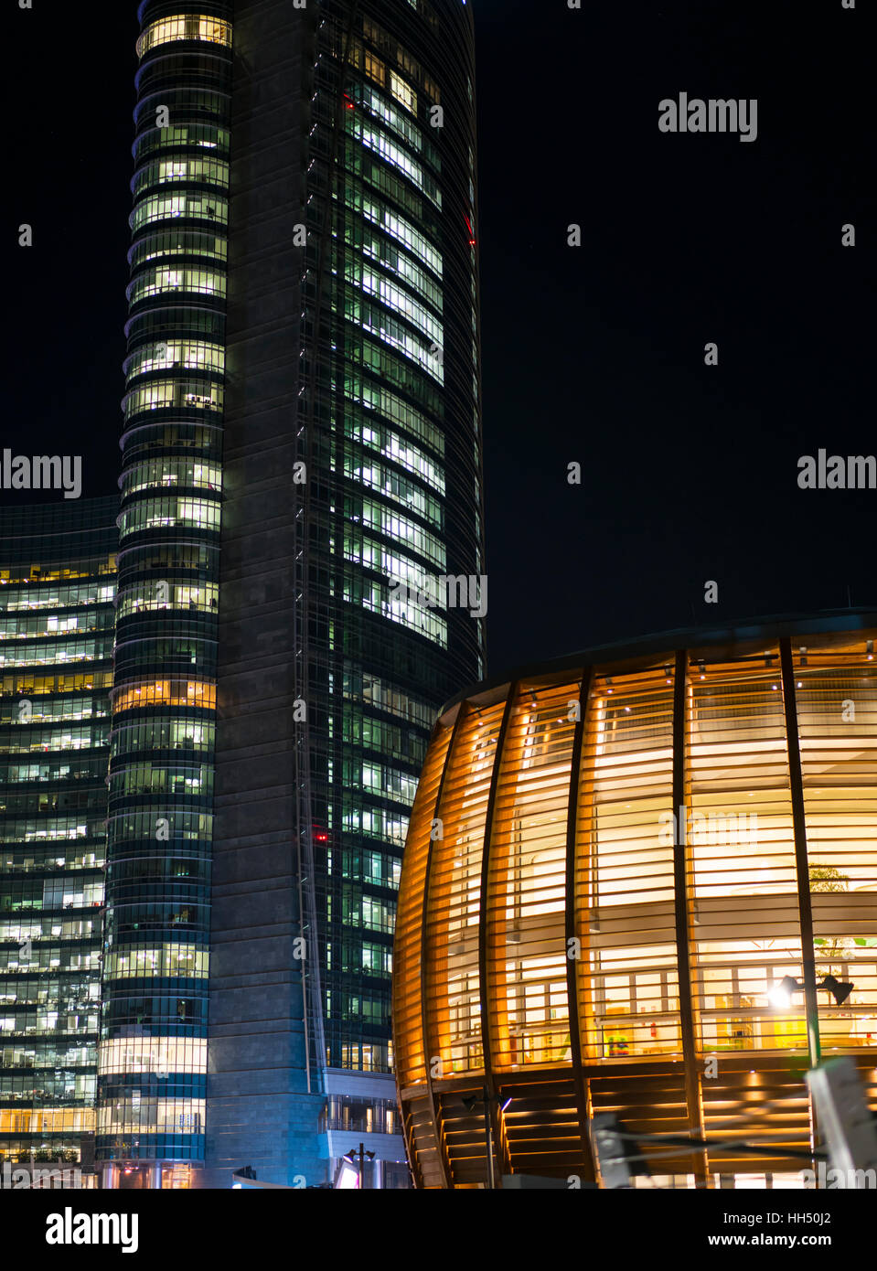 Night view of the wooden lettice pavillion in Piazza Gae Aulenti. Milan ...