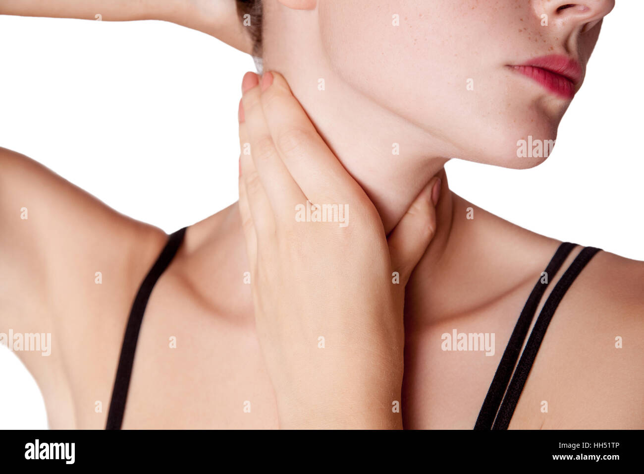 Closeup view of a young woman with pain on neck or thyroid gland. isolated on white background. Stock Photo