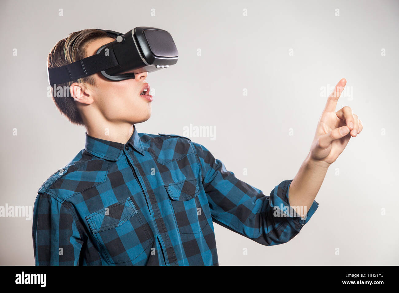 emotional funny man wearing virtual reality goggles. Studio portrait of  video game designer wearing VR headset. studio shot Stock Photo - Alamy