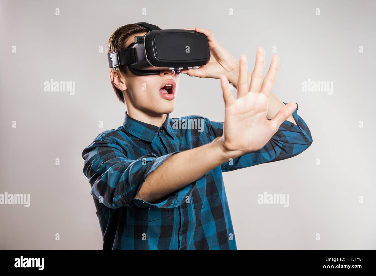 emotional funny man wearing virtual reality goggles. Studio portrait of  video game designer wearing VR headset. studio shot Stock Photo - Alamy