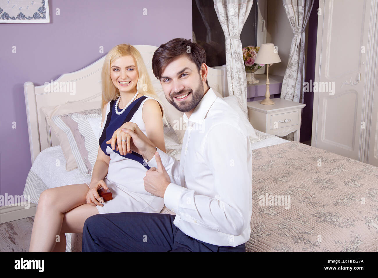 Handsome man doing a marriage proposal while offering his wife an engagement ring. Boyfriend make a marriage proposal. Stock Photo